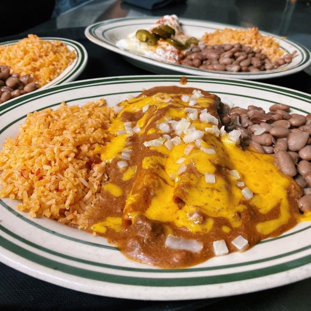 The Original's cheese enchiladas are smothered in con carne sauce and topped with raw onion.