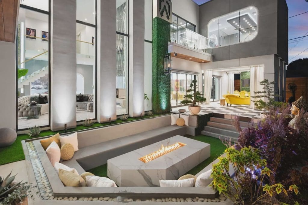 A sunken seating area surrounds a clean-lined fire pit. 