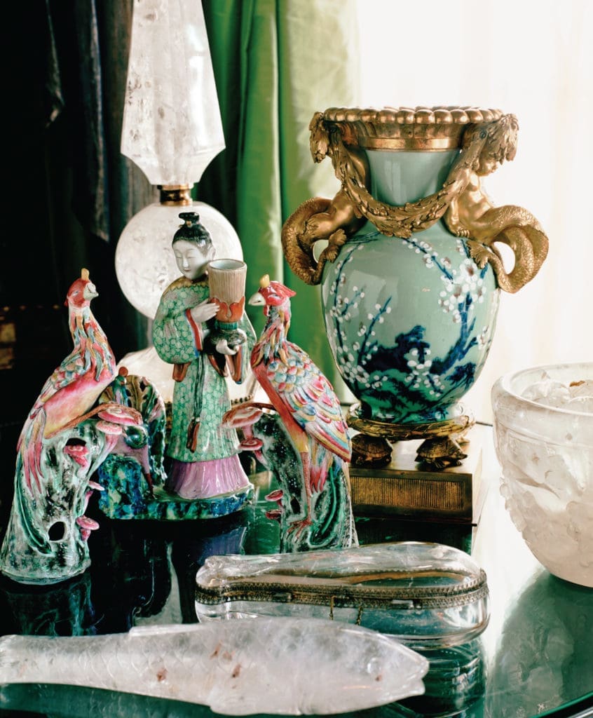 On a round table near the bay-facing windows in the living room is a “grand tour” of collections, including one of a pair of late-18th-century Chinese celadon porcelain vases later mounted with a gadrooned ormolu rim, infant tritons, and laurel swags. The pair (the second is on the Gettys’ winged cherub-ornamented table) was formerly in the collection of noted Ivorian leader Félix Houphouët-Boigny. The bowl and two Lucknow carved fish are rock crystal. (Photography by Lisa Romerein)