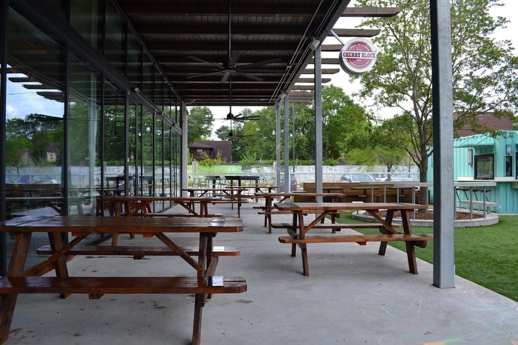 Cherry Block Smokehouse patio opens up to the greenspace at Stomping Grounds.Photo by POP Studios PR