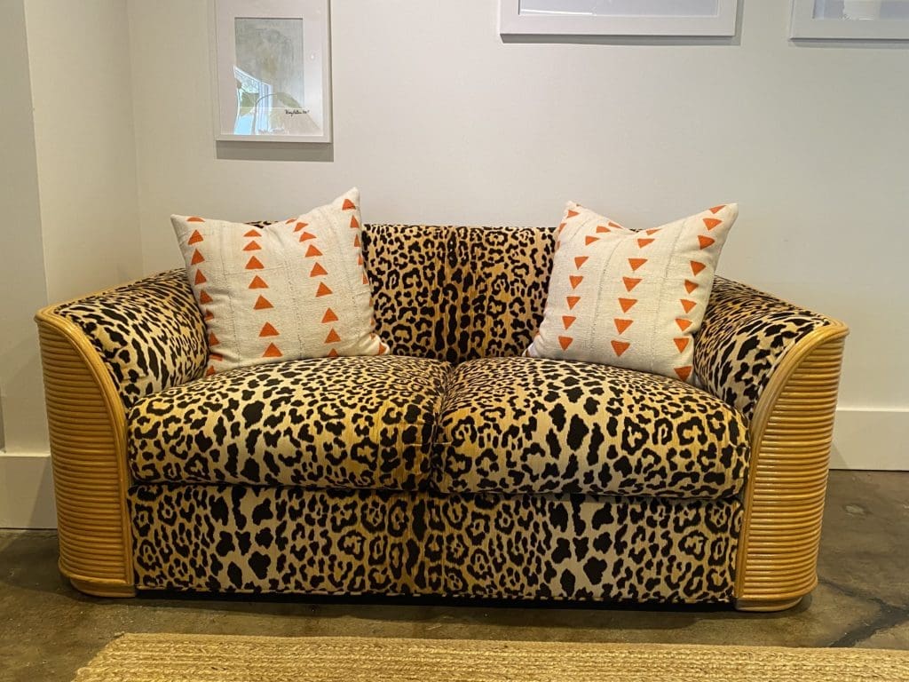 The '70s era rattan sofa and love seat have been upholstered in a velvety leopard print in the Mary Patton Design shop.