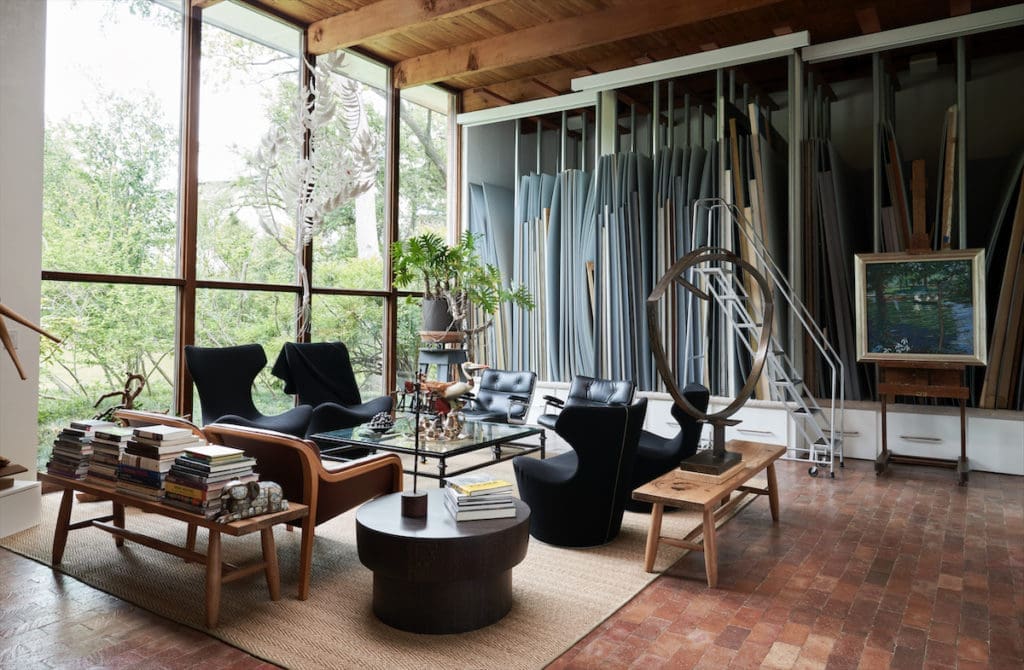 Donald Vogel’s former painting studio is now a sitting room with sculptures by Kana Harada, Alex Corno, and David Everett. Time Life leather chairs from Collage. Set of four chairs by Naoto Fukasawa. Vertical storage holds over-scale canvases from the gallery. (Photo by Pär Bengtsson / art direction by Michelle Aviña)