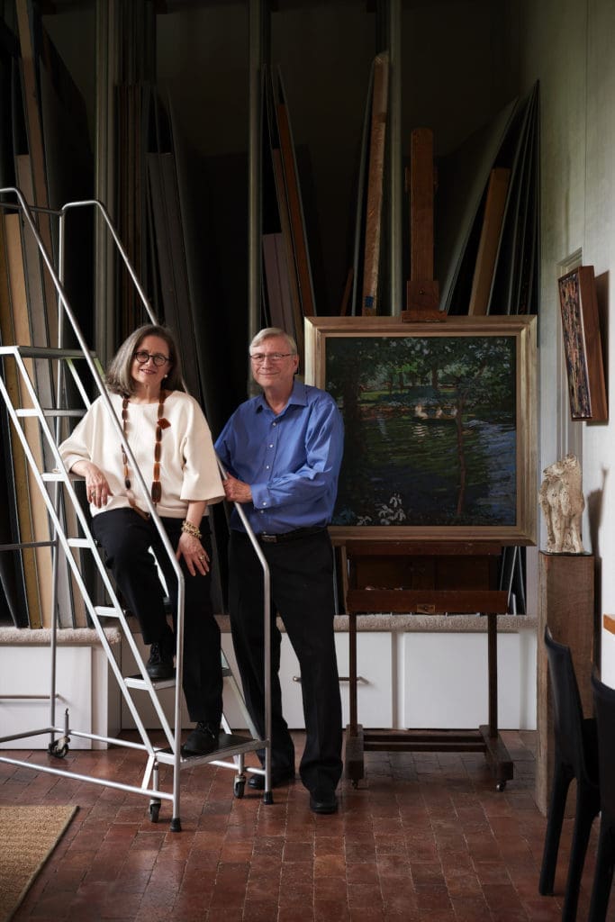 Cheryl and Kevin Vogel in Donald’s former painting studio. The painting of Kevin with his mother and brother on a boat in the pond was a wedding gift to the couple from Donald. (Photo by Pär Bengtsson / art direction by Michelle Aviña)