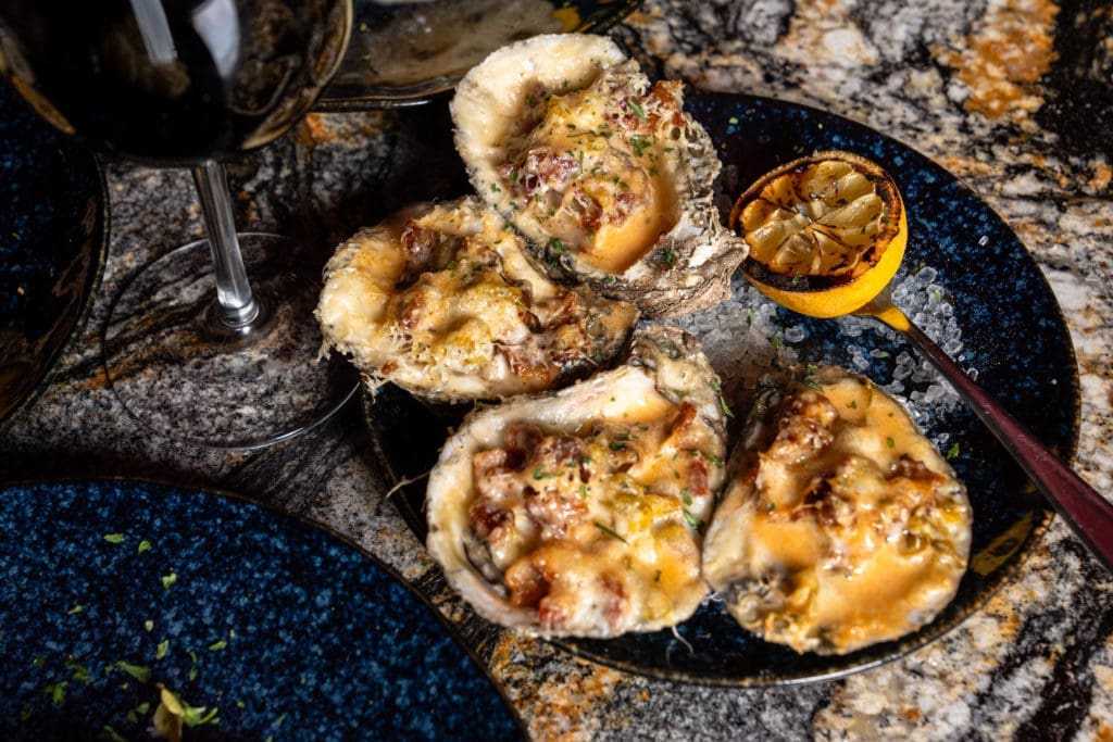 Gatsby's Prime Seafood serves several varieties of baked oysters (as well as raw). (Photo by Michael Anthony)