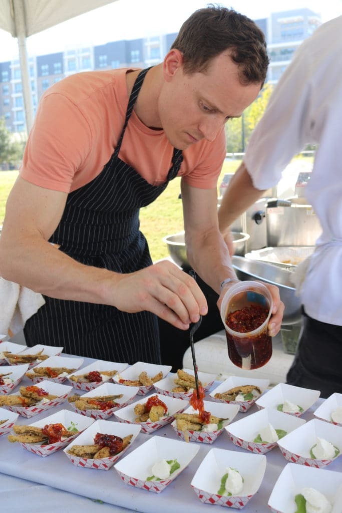 Bludorn chef prepares a dish for the inaugural Chefs for Farmers event, held at Autry Park.  (Photo by Addison Hall)