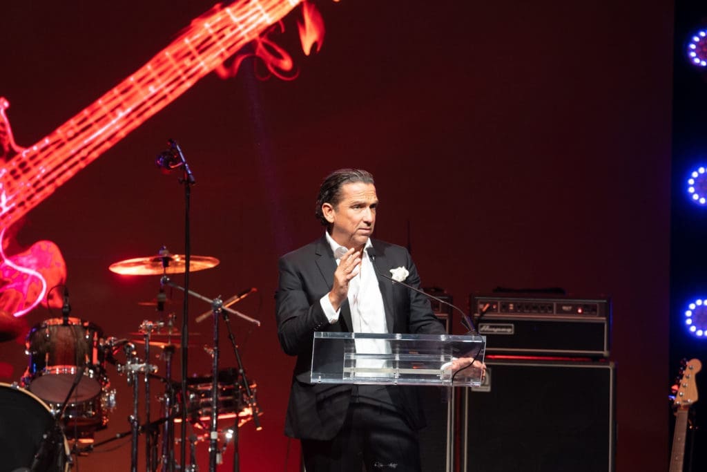 Tony Buzbee on stage raising funds to purchase wheelchair accessible vans for disabled, wheelchair-bound children (Photo by Daniel Ortiz)