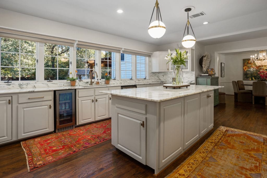 Carrara counters and a wall of windows let the sunshine flow into this gourmet kitchen.