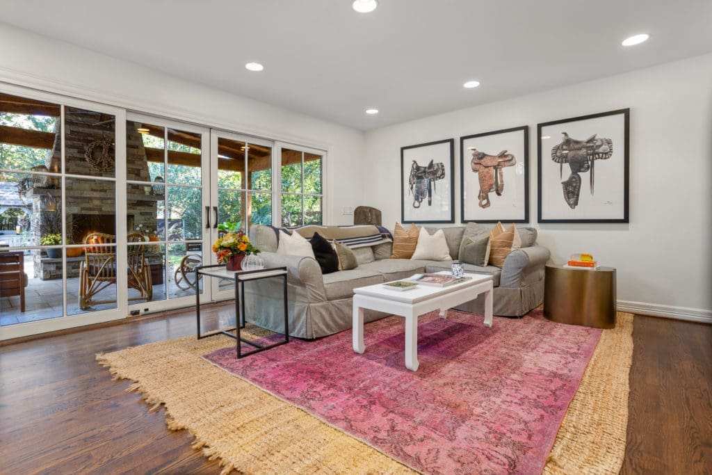 Den with warm oak under foot and a 12 foot sliding doors leading the to the covered patio.