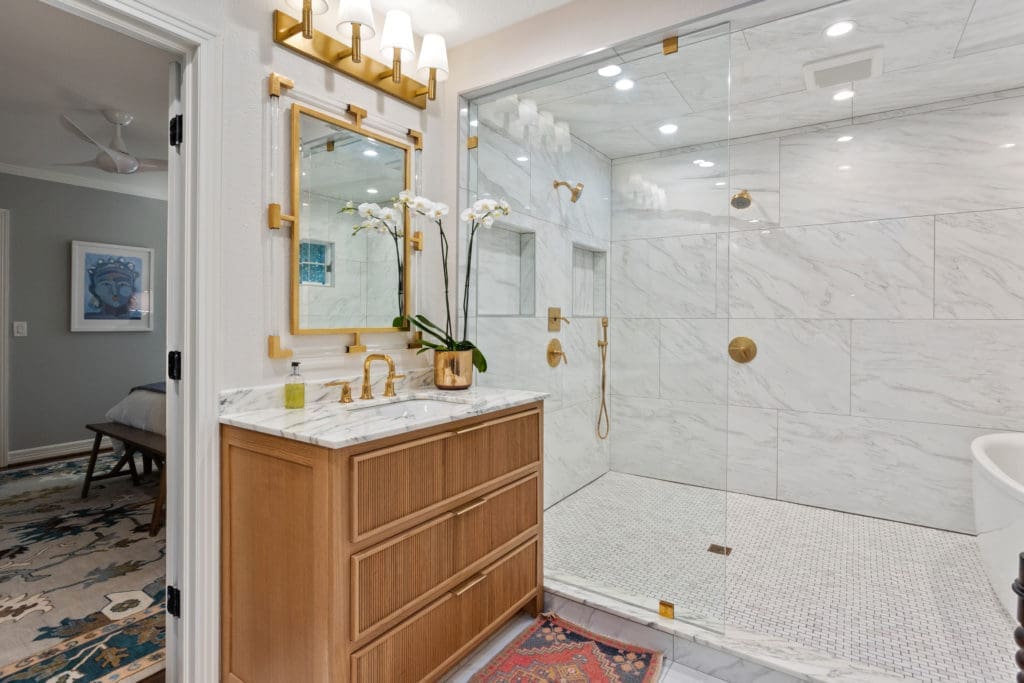 Main bath with a modern dual shower and tub wet area.