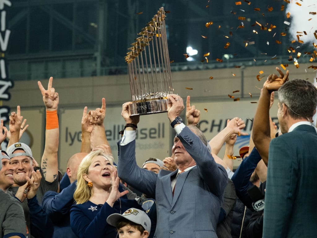Astros owner Jim Crane lifted the trophy high — and felt some tears in his eyes. (Photo by F. Carter Smith)