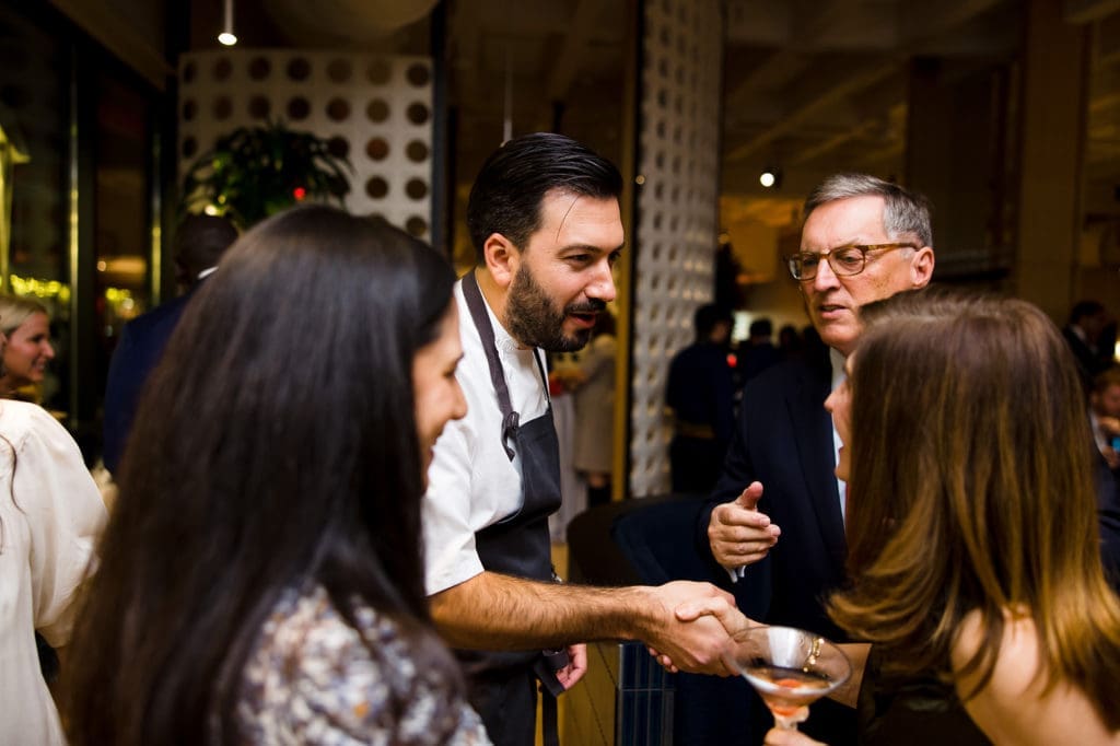 Chef Aaron Bludorn visits with guests at the Texas Children's Hospital Ambassadors Holiday Party held at Navy Blue in Rice University  (Photo by Jenny Antill Photography)