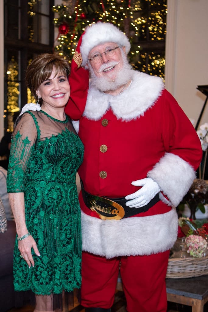 Hallie Vanderhider with Santa at the Santa's Elves Party, held at The Fertitta Family home in River Oaks,  benefitting MD Anderson Children's Cancer Hospital.