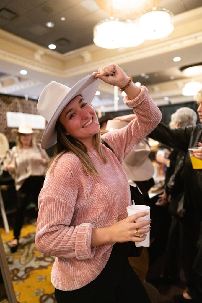 Katherine Sarvadi modeling her new hat, purchased at the 2022 the Sale. (Photo by Daniel Ortiz)