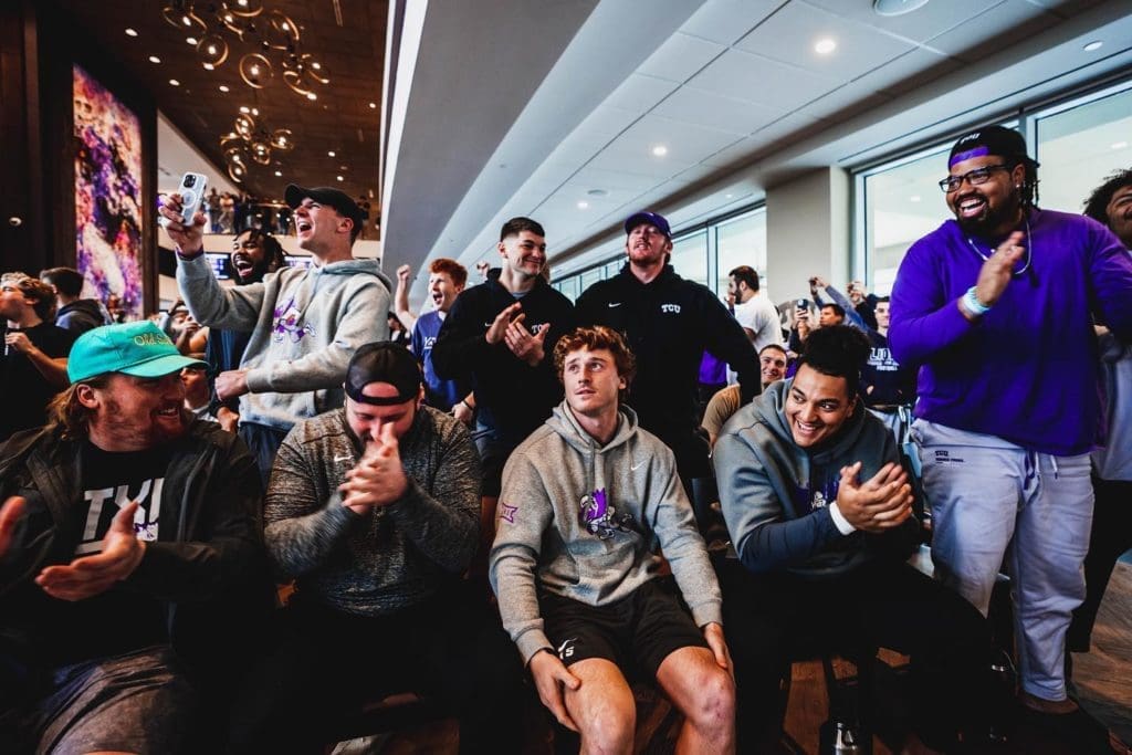 Max Duggan surrounded by team mates the moment it was announced that the team was headed to the College Football Playoffs.