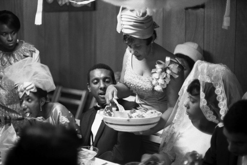 Gordon Parks' "Untitled, Bronx, New York," 1967. The scene shows Mary Charles Carmichael serving her children Lynette and Stokely at Lynette's wedding dinner in the Bronx. (Courtesy The Gordon Parks Foundation)