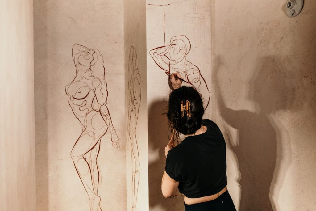 Artist Haley Bowen creates a mural for the latest restaurant by The Big Vibe Group in the Montrose Collective. (Photo by Kirsten Gilliam)