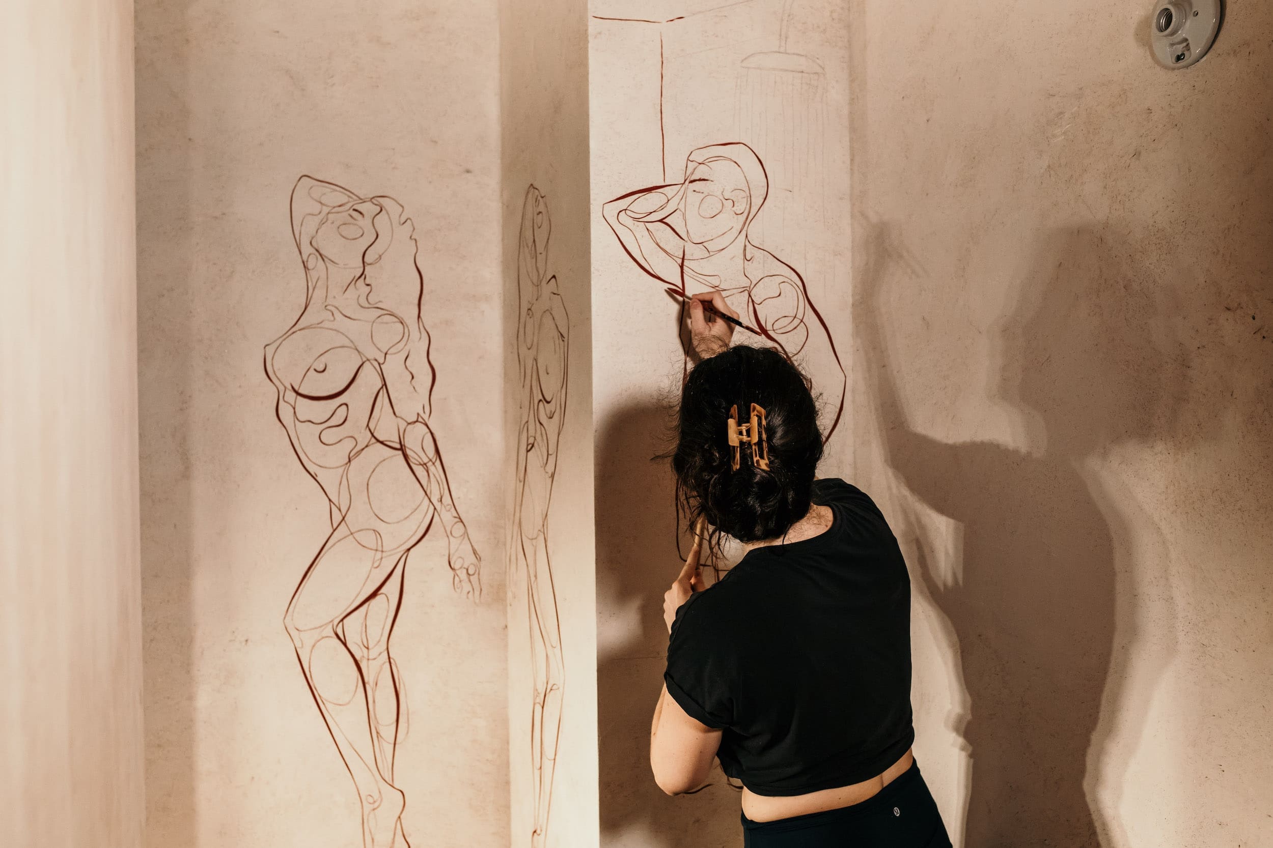 Artist Haley Bowen creates a mural for the latest restaurant by The Big Vibe Group in the Montrose Collective.
