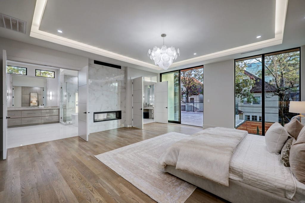The double-sided fireplace at 275 Pine Hollow Lane heats both the master suite and master bath. (Photo by TK Images)