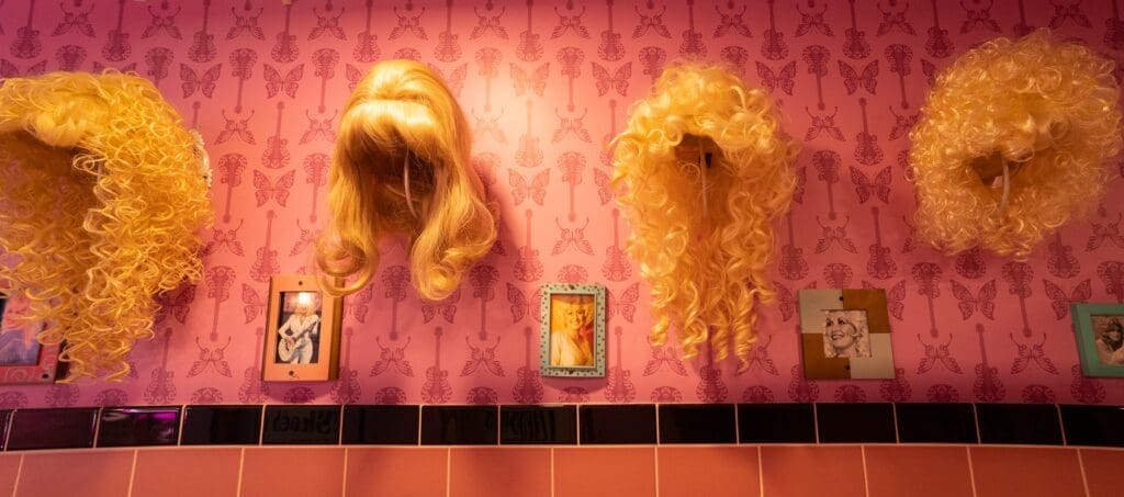 The ladies room is filled with Dolly Parton wigs and photos.