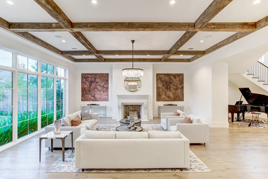 An open floor plan with elevated wood flooring and beams in 5554 Longmont Drive by Sims Luxury Builders created the perfect mix when Moni sold this property in 2021. (Photo TK Images)