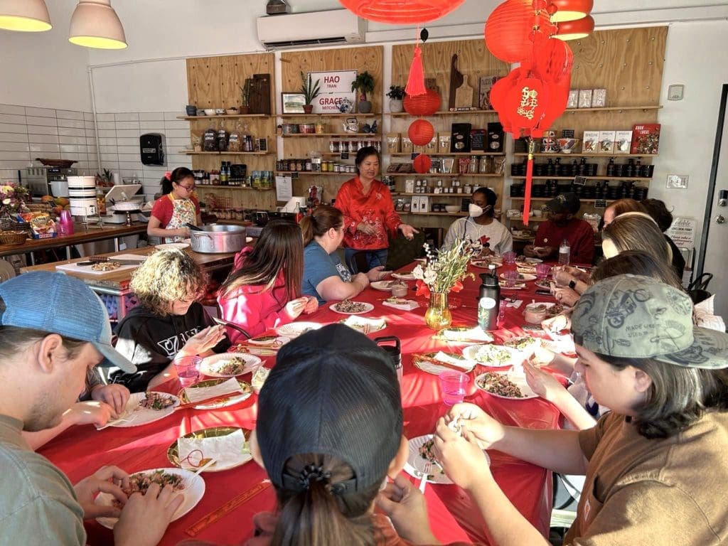 Hao Tran teaches guests how to perfect their own dumplings at a recent Dim Sum party.