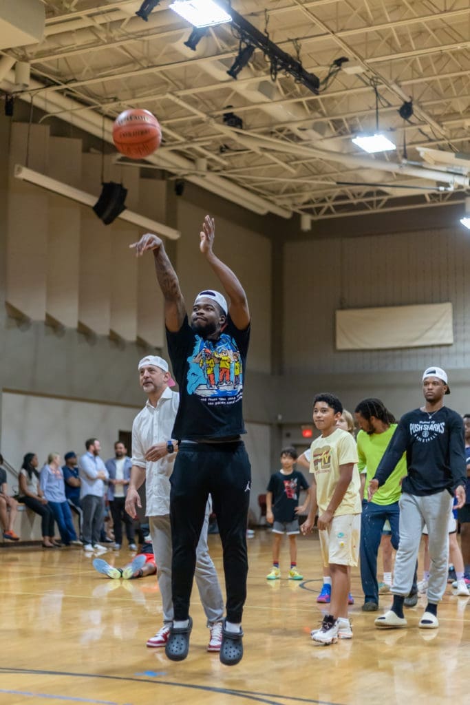 UH point guard Jamal Shead played some shooting games with the kids at the New Leaf event. (Courtesy New Leaf real estate) 