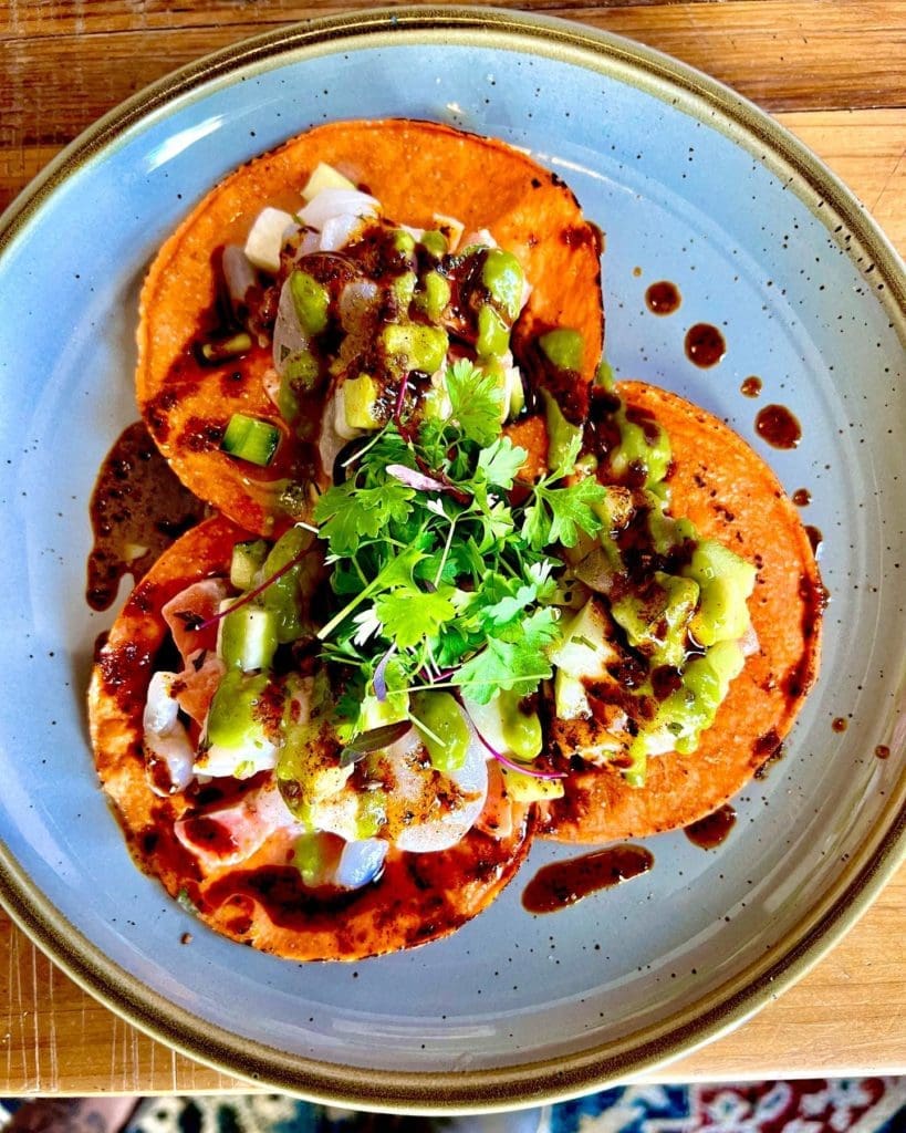 La Onda - A seafood campechana with scallops, bay scallops, and coho salmon in aji basil aguachile served on tostadas.