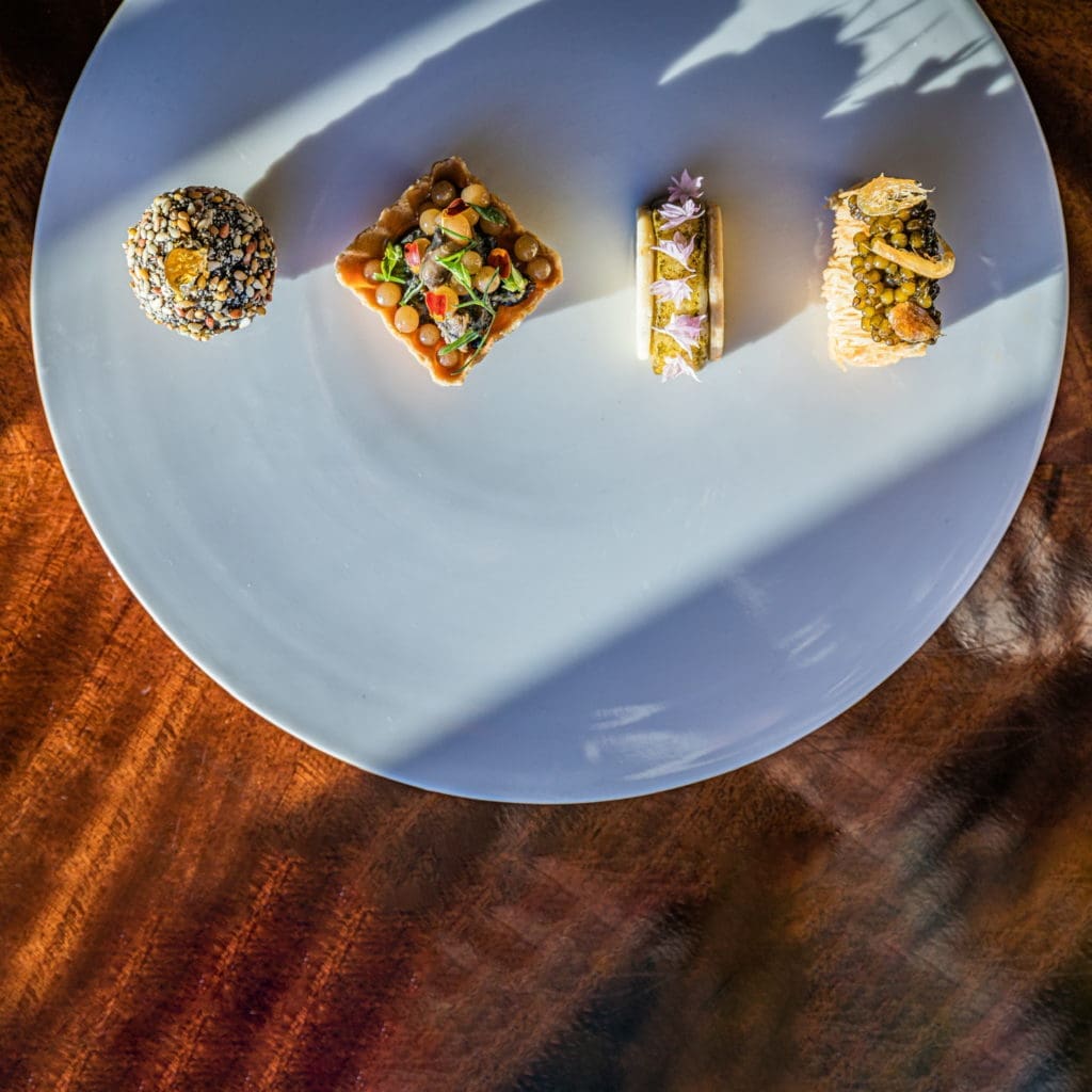 The Greek Tile sampler at March Lounge brings a lot to the table. Left to Right: Loukoumas and foie gras; olive oil & escargot; grape and halloumi; kataifi and shrimp. (Photo by Zach Horst)