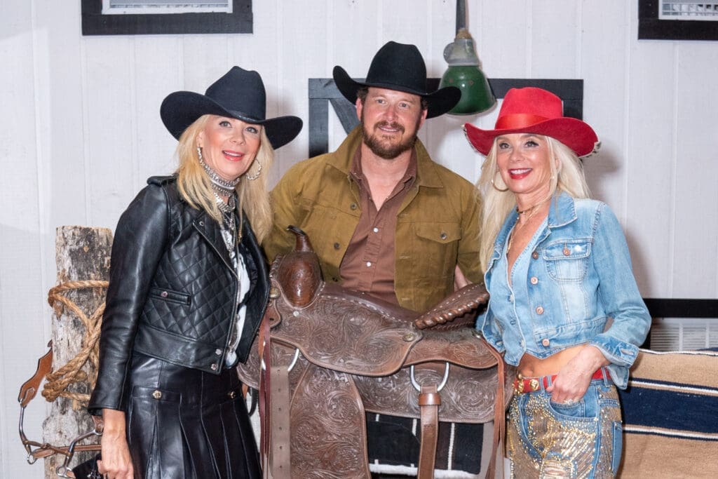 Tena Lundquist Faust and, Tama Lundquist with Cole Hauser, Yellowstone's Rip Wheeler, on stage during a special appearance at The Ranch Saloon + Steakhouse at the Houston Livestock Show and Rodeo. (Photo by Jacob Power))