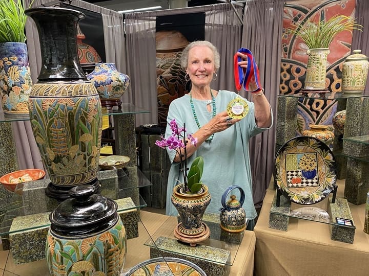 Cathra-Anne Barker shows off her Best of Show medal from The Woodlands Waterway Arts Festival. (Photo courtesy The Woodlands Arts Council)