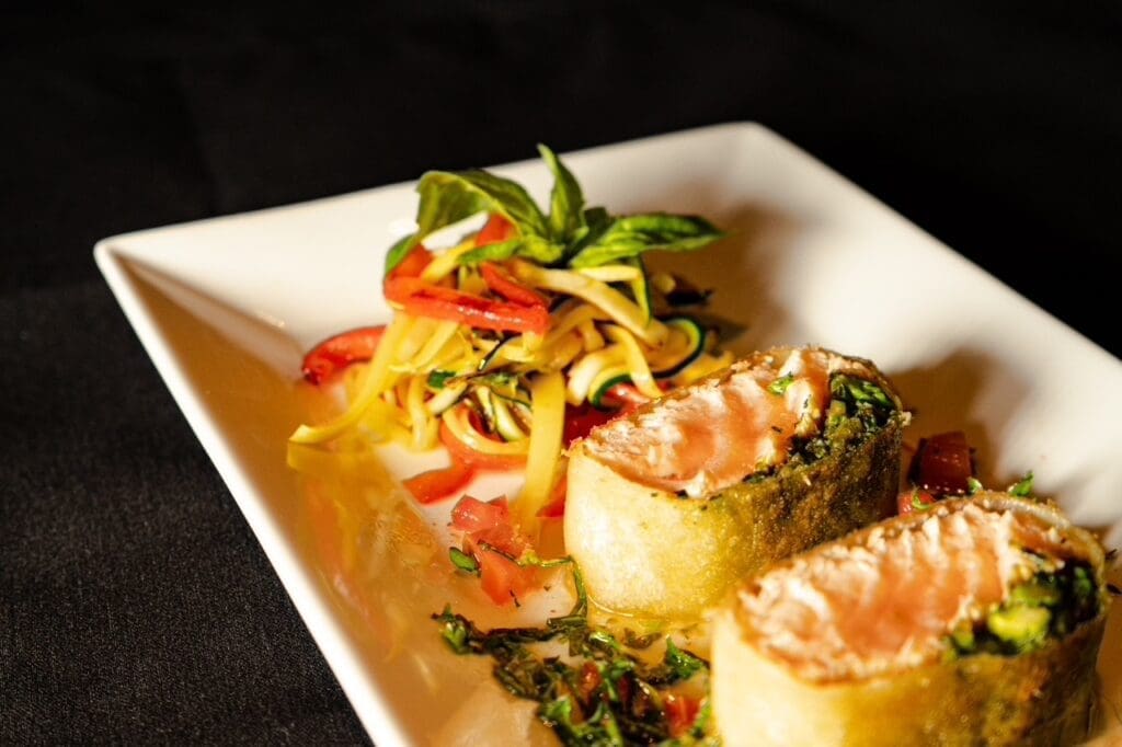 Crispy salmon ($27), three medallions encircling a dollop of asparagus pesto before its wrapped in a crispy brick pastry served with a zucchini and pepper relish. (Photo by Interiors: Raydon Creative, Food and Drink: Harold Cua)