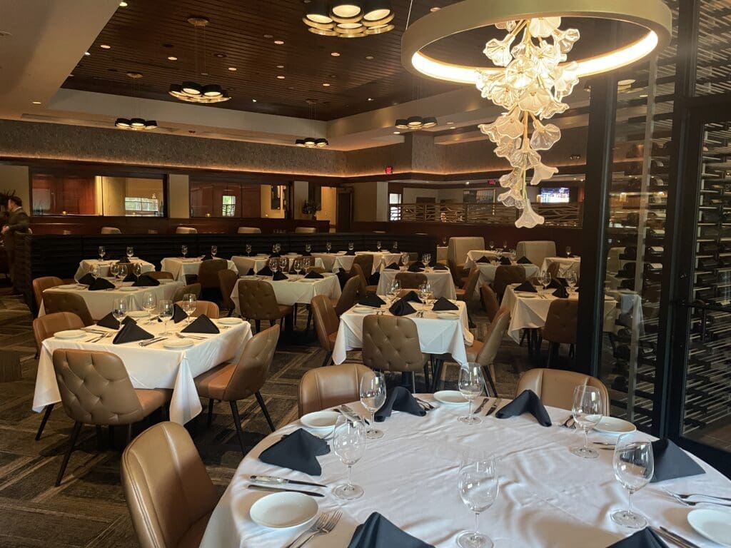 The Woodlands Fleming's floral chandelier adds to the Texas feel, next to the new glass wine area.