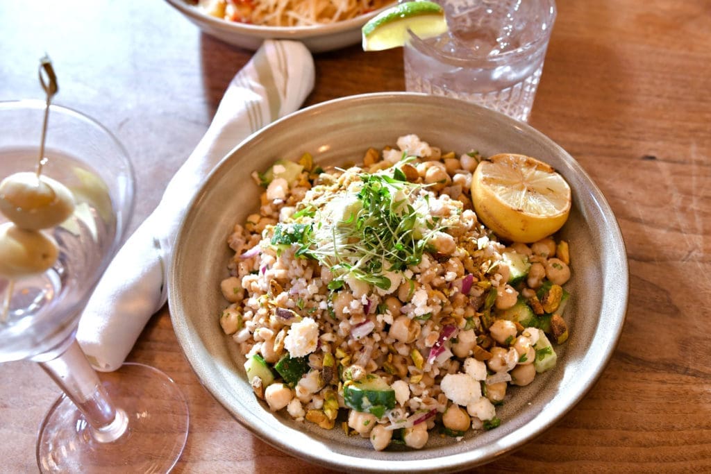 The "Not Jennifer Aniston's Salad" is tossed with farro, pistachio, chickpea, parsley, mint, cucumber, olive oil, feta, red onion and lemon—photo by Alex Montoya.