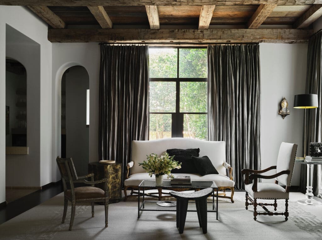 A sitting area in the living room includes a mix of the homeowner’s antiques and new contemporary pieces such as bronze and Lucite tables. (Photo by Douglas Friedman)