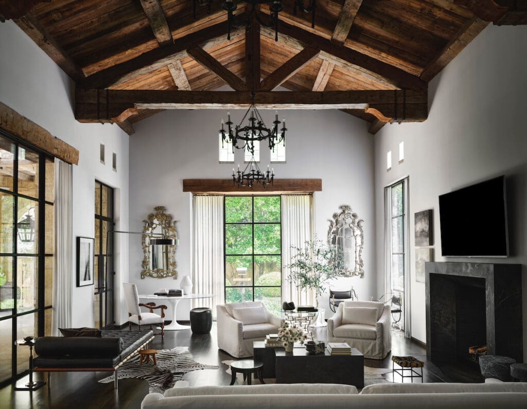 The family room with a Knoll Saarinen table and Barcelona chaise, and vintage furnishings including a pair of Venetian mirrors. (Photo by Douglas Friedman)