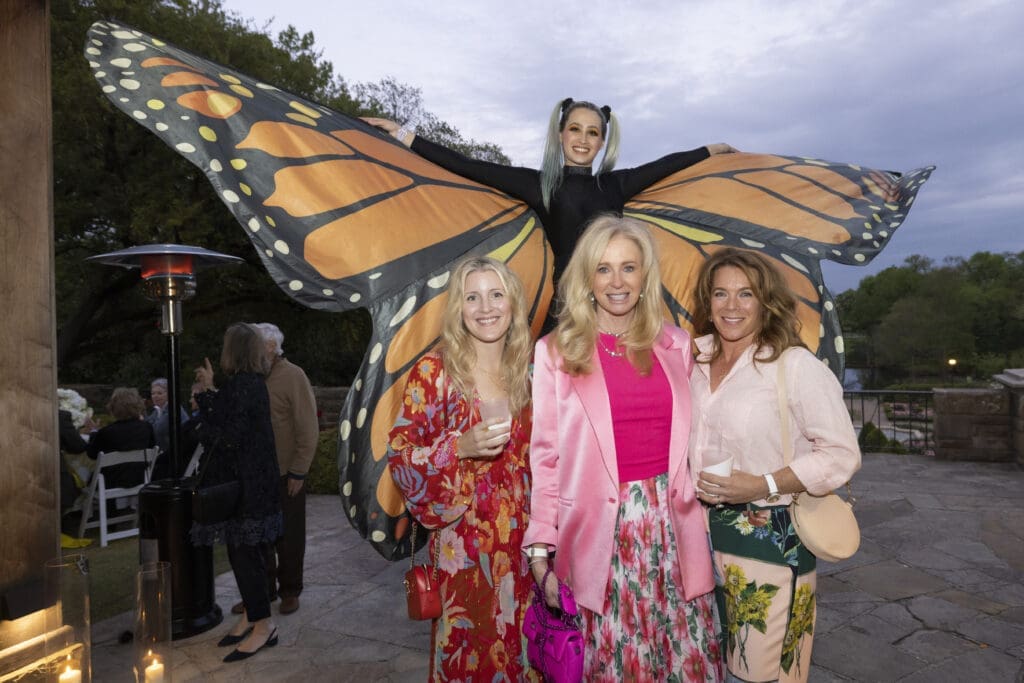 Megan Converse, Paige Randel, and Brenda Sherwood pose with a larger-than-life butterfly at the Fort Worth Garden Club Evening in the Garden. (Photo by Ellman Photography)