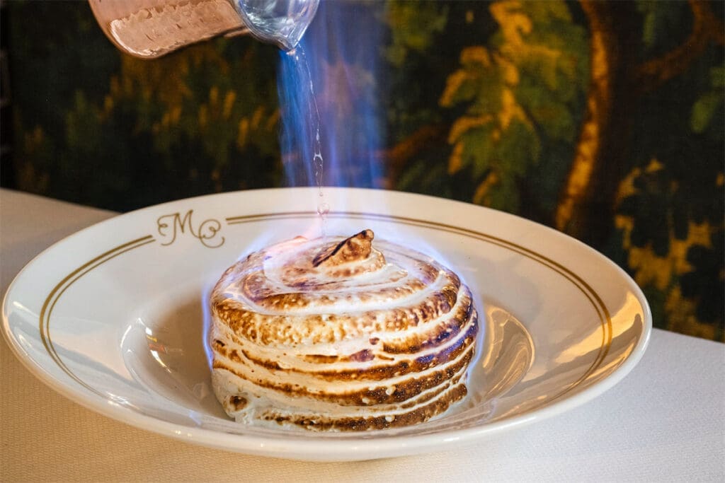 If you’re a banana lover like Megan Ziots, the Baked Alaska at Duro Hospitality’s crown jewel, Mister Charles, is a must-try. (Photo by Evan Sung)