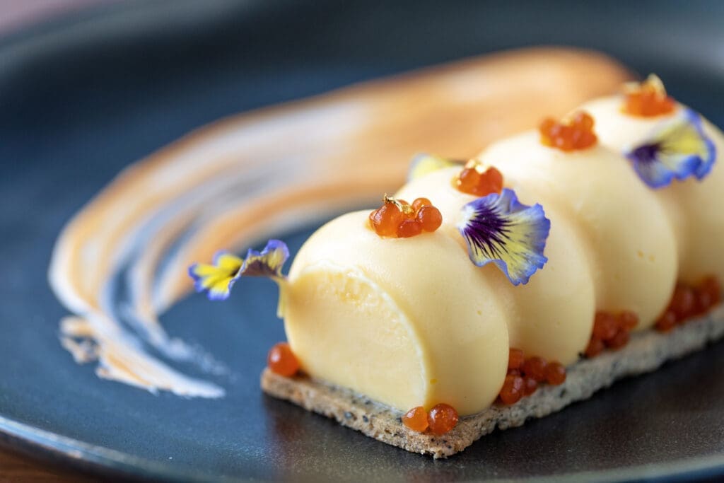 The yuzu tart with elevated lemon meringue vibes — is a sophisticated assemblage of sesame shortbread dressed with yuzu curd, toasted Italian meringue, and oolong tea caviar ($16) is a Muse dish. (Photo by Adrian Barboza and Dylan McEwan)