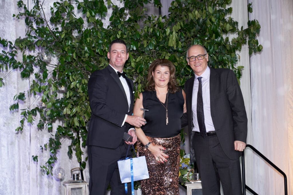 John Robichau (l) with the winners of the 2 carat white gold solitaire earrings.