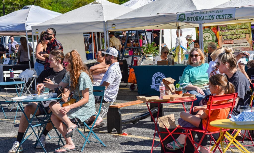 Market-goers relax in the seated area of The Woodlands Farmer’s Market at Grogan’s Mill. Photo by Jessica T. Payne