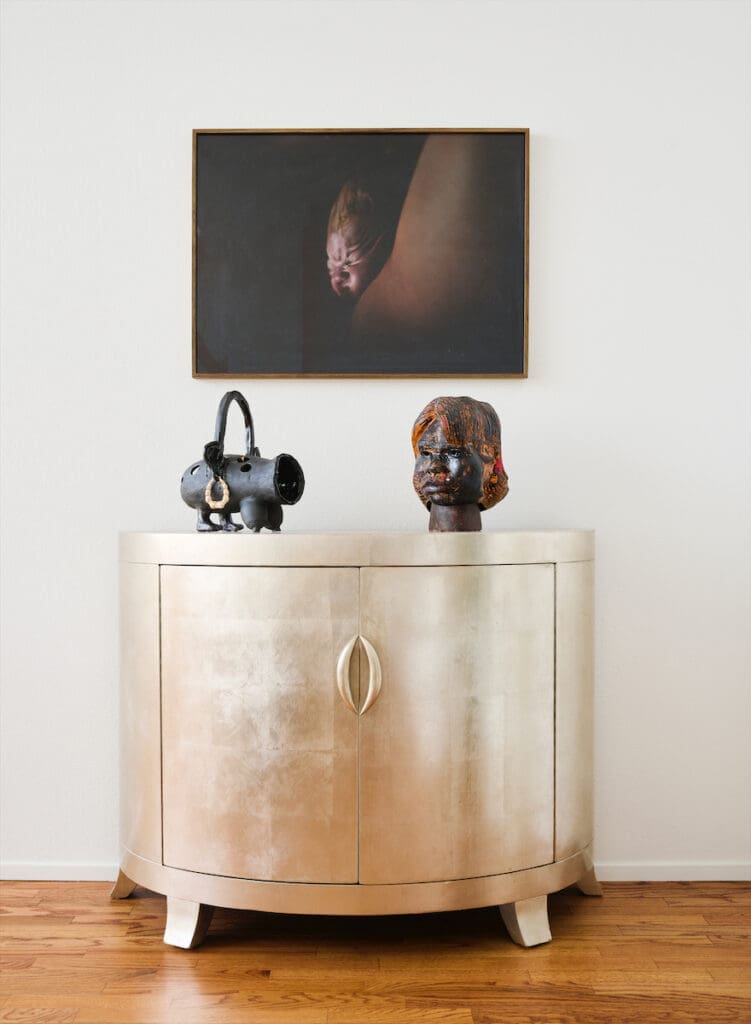 In the main bedroom, a photograph by Heji Shin. From left, sculptures by Cauleen Smith and Pope.L. (Photo by Jack Thompson)