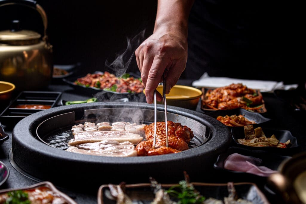 Galbi Pork Belly and Spicy Gangnam Chicken is cooked on the grill at the new Korean BBQ restaurant called Hongdae 33. (Photo by Jenn Duncan)