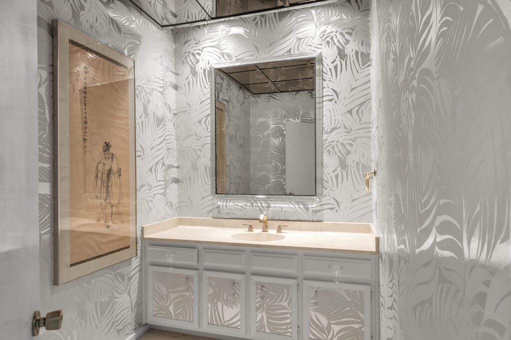 Silvered palms still sway in a guest bathroom.