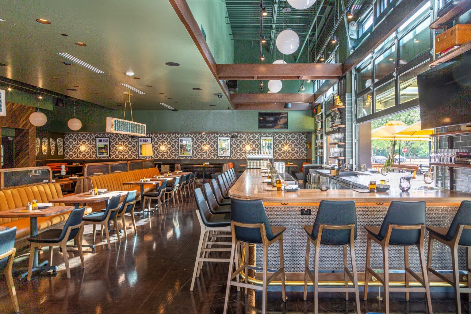 Booths, bar seating and and couches give Postino Woodlands diners plenty of room to relax. (Photo by Jenn Duncan)