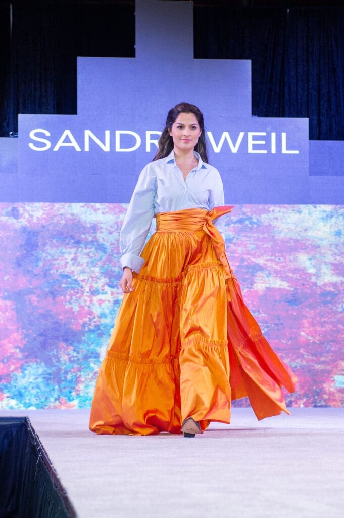 Sandra Weil fashions on the catwalk at the Latin Women's Initiative fashion show and luncheon.  (Photo by Jacob Power)