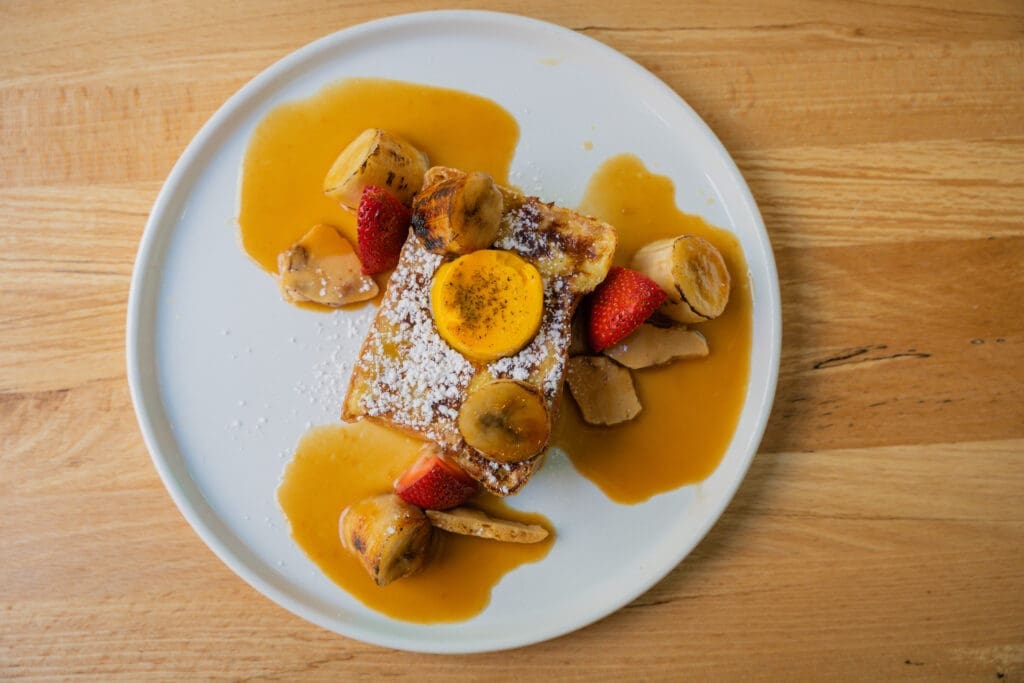 Citizens of Montrose's signature banana French toast ($13.50) features slices of maple-sweetened banana bread served with bruleed banana slices, mascarpone, and a miso butterscotch drizzle. (Photo by Courtesy of Citizens)