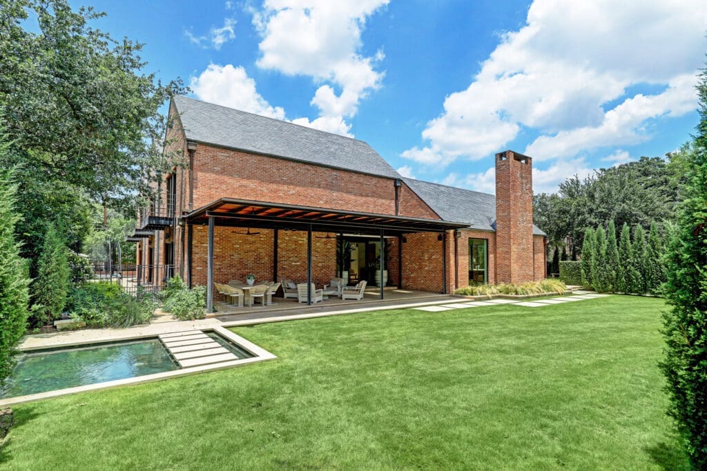 The spacious side yard at 3404 Chevy Chase where a water feature captures attention. (Photo by TK Images)