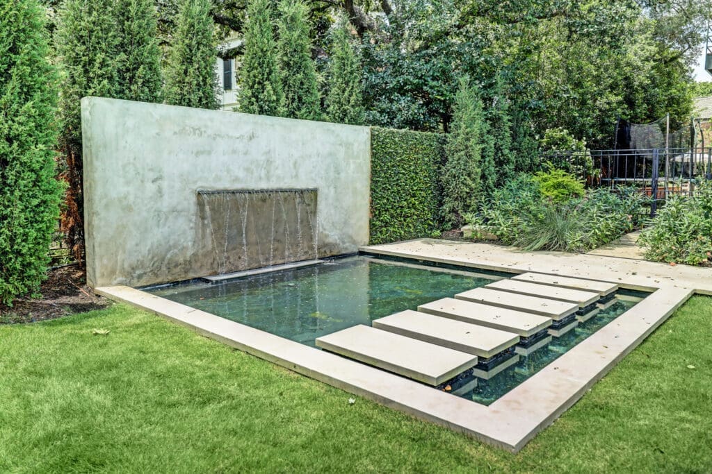 The spacious side yard at 3404 Chevy Chase features a water feature that captures attention. (Photo by TK Images)