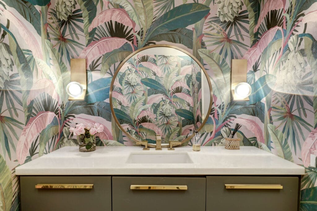Whimsical wallpaper of palm fronds in both the breakfast nook and in the guest bathroom. (Photo by TK Images)