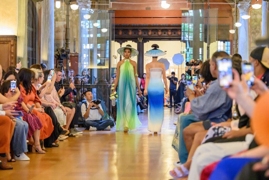 Green and blue dresses by Chloe Dao modeled by Koko Burton and Rina Liou at the Ascend AAPI Spring Fashion Show (Photo by Ken Jones)